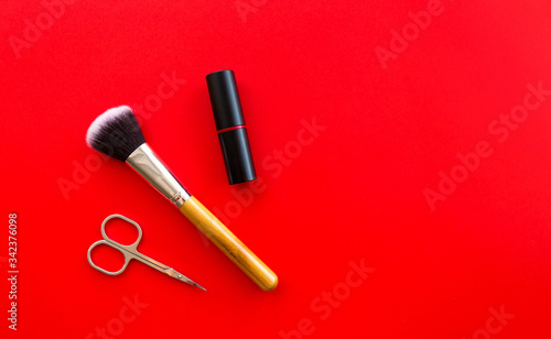 Fototapeta Naklejka Na Ścianę i Meble -  Set of professional decorative cosmetics, makeup tools and accessory on red background. Beauty, fashion and shopping concept. flat lay composition, top view