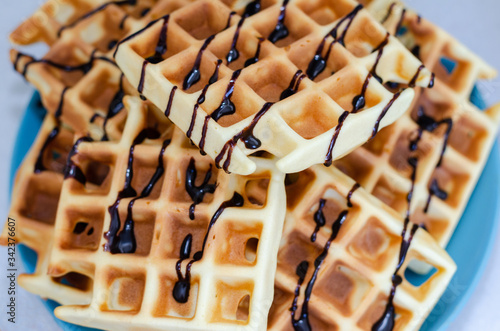 homemade Viennese waffle with chocolate topping waffle maker on a plate