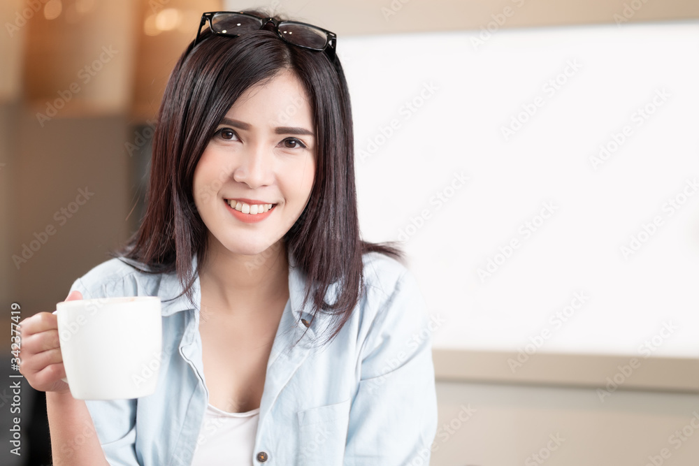 Close up Beautiful asian woman drink coffee while sitting at home with copy space. Relaxation Lifestyles Close up Beautiful asian woman drink coffee while sitting at home with copy space. Relaxation Lifestyles
