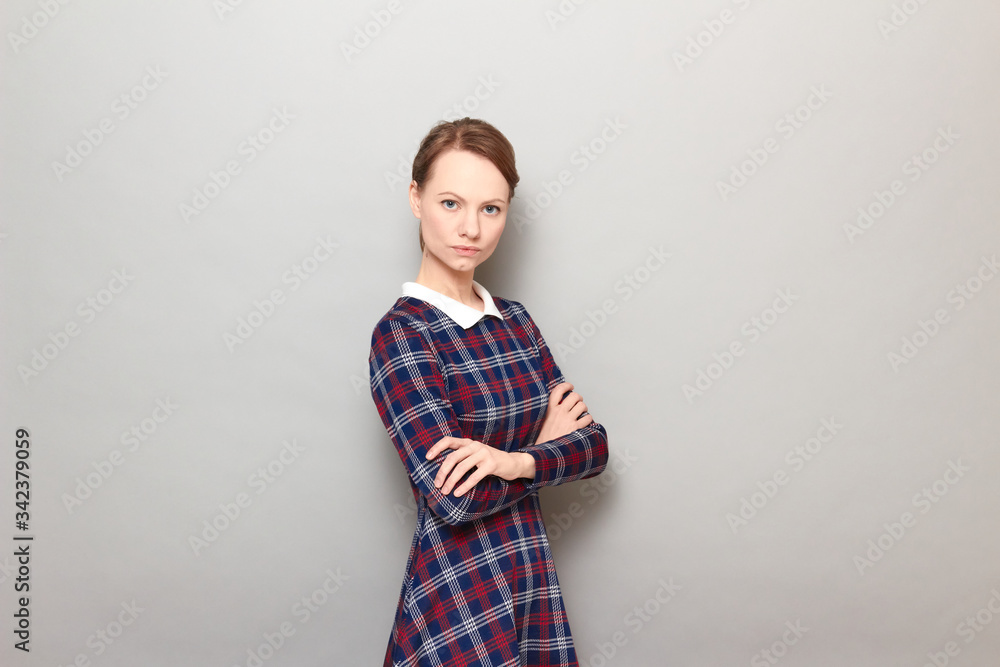 Portrait of serious focused young woman holding arms crossed on chest Portrait of serious focused young woman holding arms crossed on chest