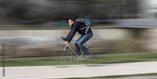 Young man riding to work on a bicycle. 