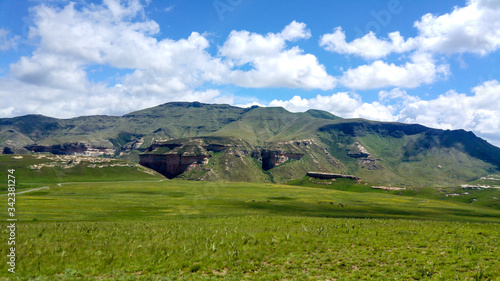 Fluffy clouds over rock formations in the Golden Gate Highlands National Park, Clarens, Free State, South Africa