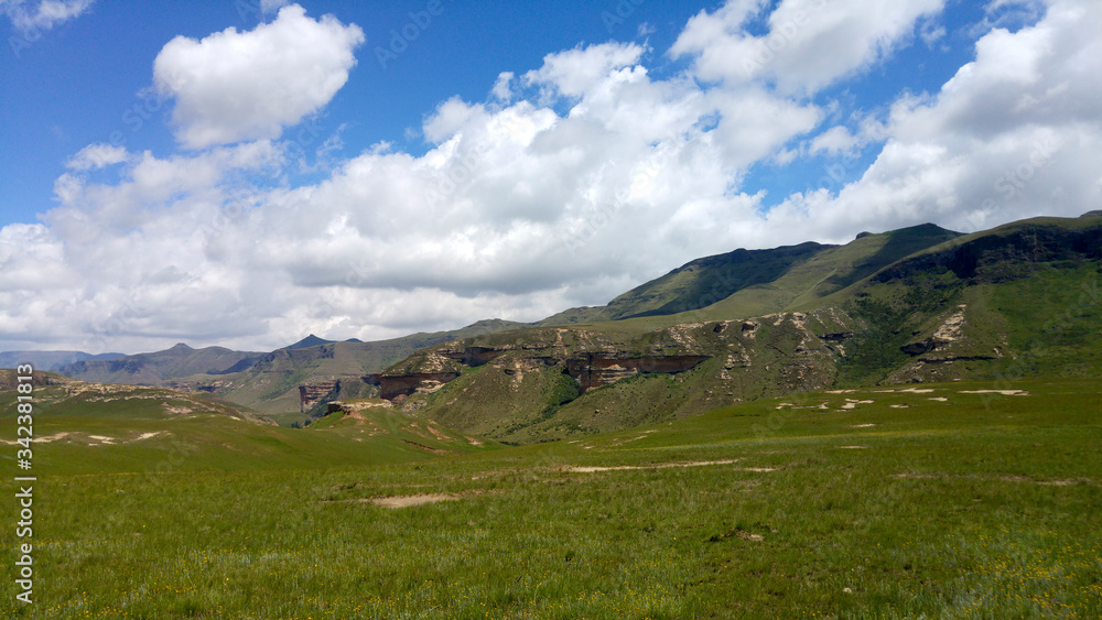 Fluffy clouds over rock formations in the Golden Gate Highlands National Park, Clarens, Free State, South Africa Fluffy clouds over rock formations in the Golden Gate Highlands National Park, Clarens, Free State, South Africa