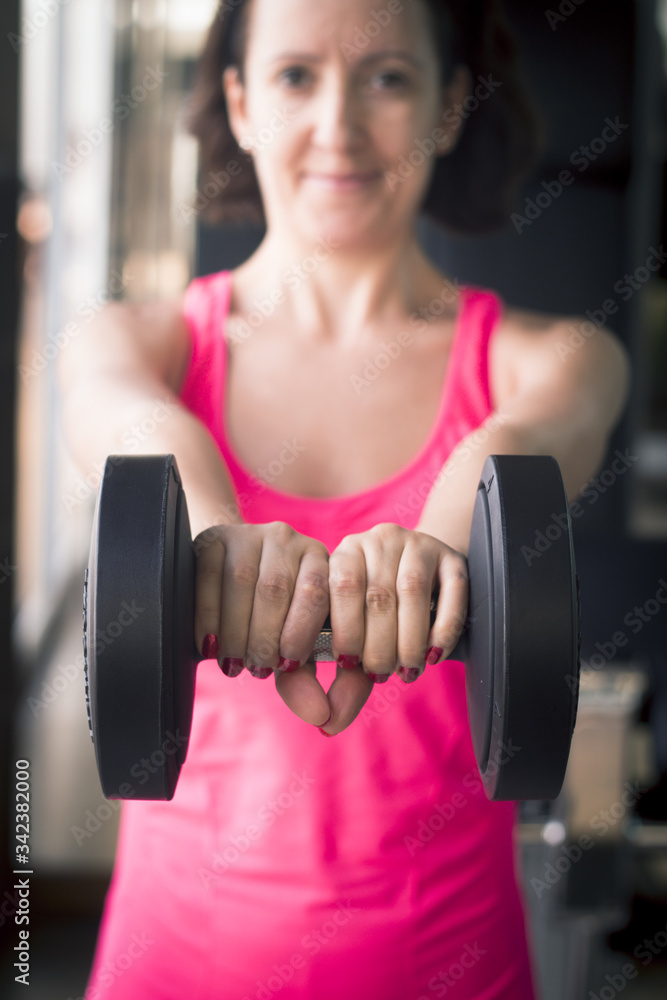 Thin thirties woman doing exercise in the gym Thin thirties woman doing exercise in the gym