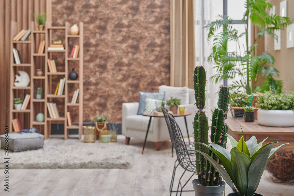 Fototapeta premium Decorative brown interior room, wooden bookcase background, grey armchair, coffee table and parquet detail.