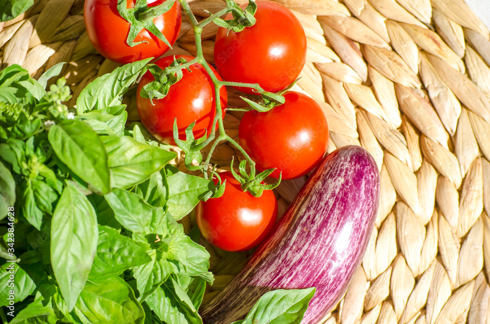 Raw vegetables close up. Vegetables on table against background of white wall. view of fresh tomatoes, basil, eggplant, red pepper. Healthy eating concept. Selective focus image. Raw vegetables close up. Vegetables on table against background of white wall. view of fresh tomatoes, basil, eggplant, red pepper. Healthy eating concept. Selective focus image.