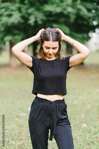 Stylish hipster girl in black t-shirt on the street posing