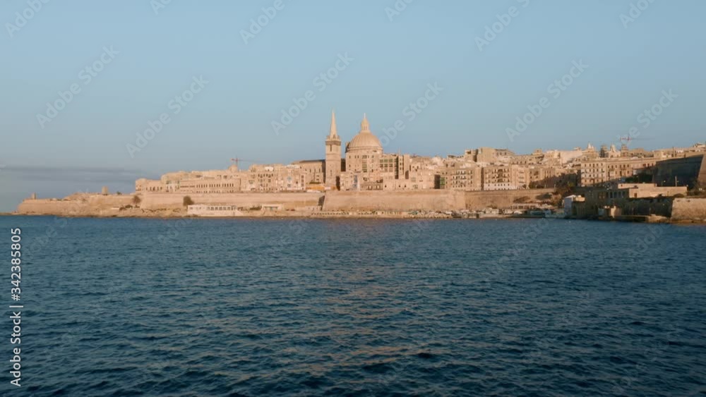 Aerial view of Valletta city, church and dome. Sunset time, clear blue sky. Mediterranean sea. Europe. Malta country Aerial view of Valletta city, church and dome. Sunset time, clear blue sky. Mediterranean sea. Europe. Malta country
