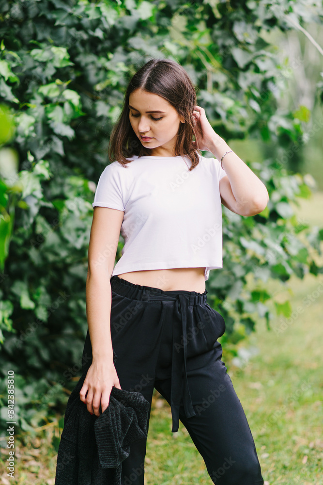 Stylish hipster girl in white t-shirt outdoors posing Stylish hipster girl in white t-shirt outdoors posing