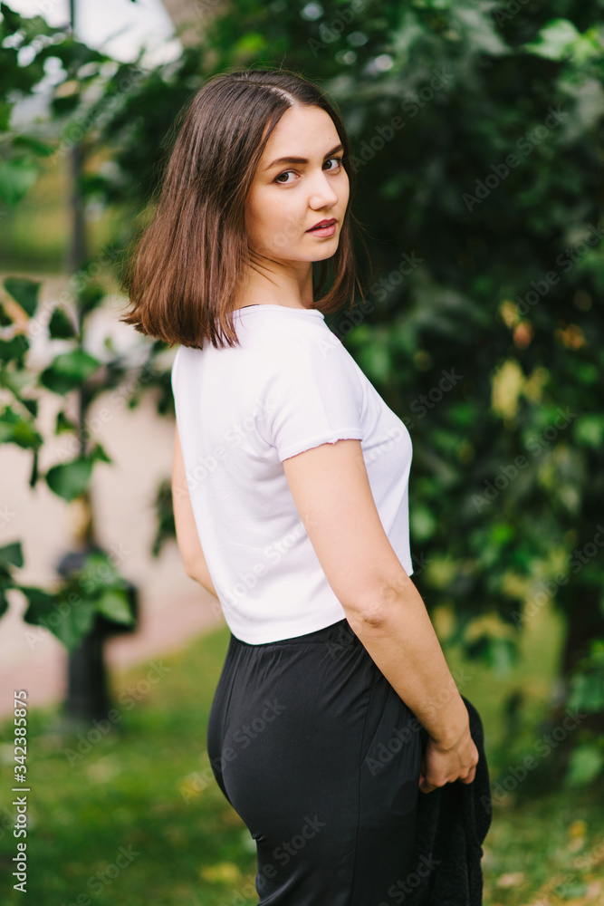 Stylish hipster girl in white t-shirt outdoors posing Stylish hipster girl in white t-shirt outdoors posing