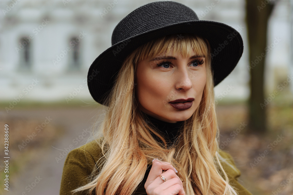 Blond girl with bangs in black hat Blond girl with bangs in black hat