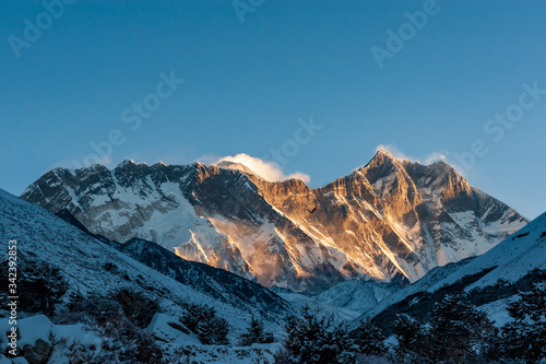 Sunrise on Nuptse, Lhotse and Mount Mt. Everest peaks with bird of prey at front. Trekking in Nepal Himalayas. EBC (Everest base camp trek) trail upper part from Lukla to EBC of Everest trek. Nepal.