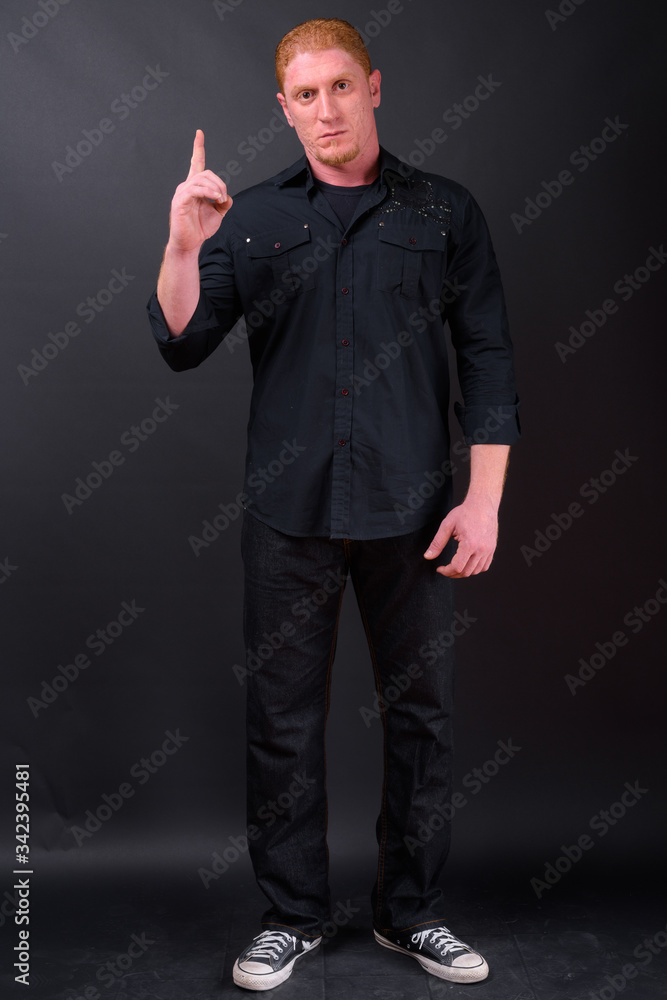 Full body shot of muscular man with orange hair Full body shot of muscular man with orange hair