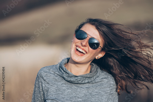 Caucasian woman enjoying wind and nature.