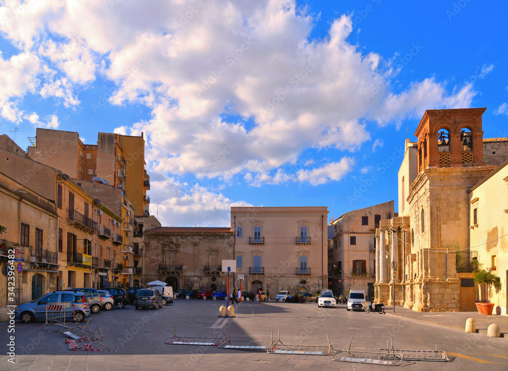  little square with old classical colorful buildings, church dome and cloudy blue sky in coastal town Licata in Sicily, Italy