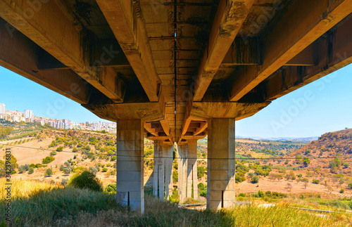 Detail of Ponte Morandi bridge structure with city of Agrigento in background on hill. photo