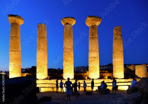 Ruined Temple of Heracles columns in famous ancient Valley of Temples on blue hour sunset in summer evening, Agrigento, Sicily, Italy. UNESCO World Heritage Site.