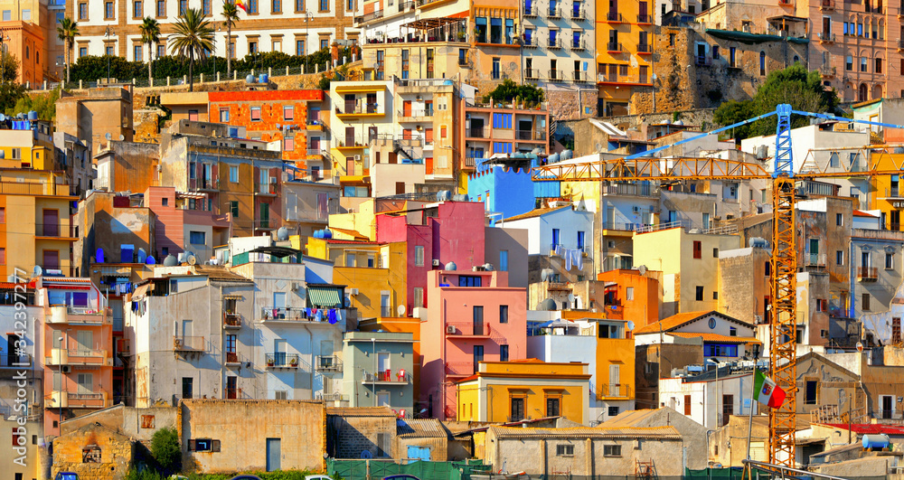 The colorful old houses with windows in city of Sciacca overlooking its harbour. Province of Agrigento, Sicily.