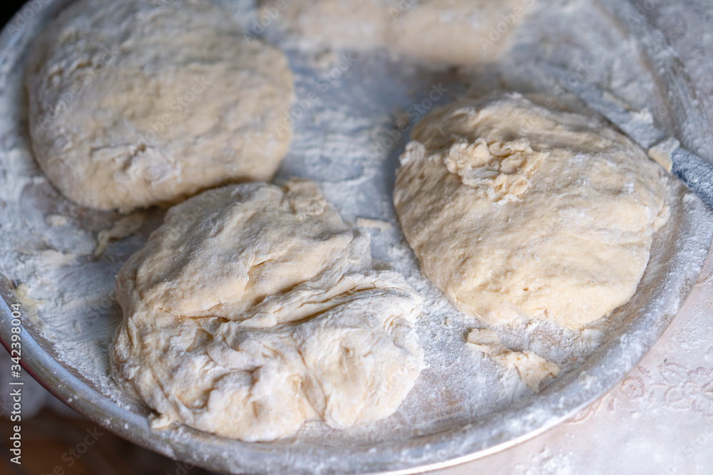 Flour dough sprinkled on a tray Flour dough sprinkled on a tray