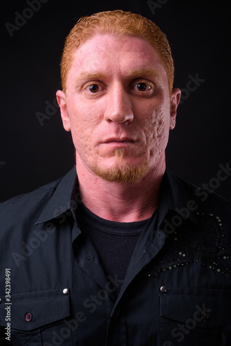 Face of muscular man with orange hair