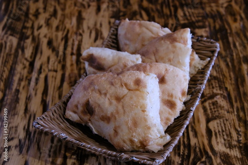 Pieces of pita bread in a basket on a table. Lavash is unleavened white bread in the form of a thin tortilla made of wheat flour, distributed mainly among the peoples of the Caucasus, Iran, Afghanista