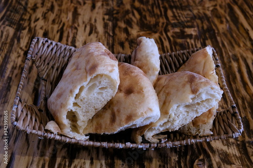 Pieces of pita bread in a basket on a table. Lavash is unleavened white bread in the form of a thin tortilla made of wheat flour, distributed mainly among the peoples of the Caucasus, Iran, Afghanista