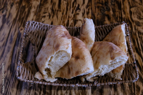 Pieces of pita bread in a basket on a table. Lavash is unleavened white bread in the form of a thin tortilla made of wheat flour, distributed mainly among the peoples of the Caucasus, Iran, Afghanista