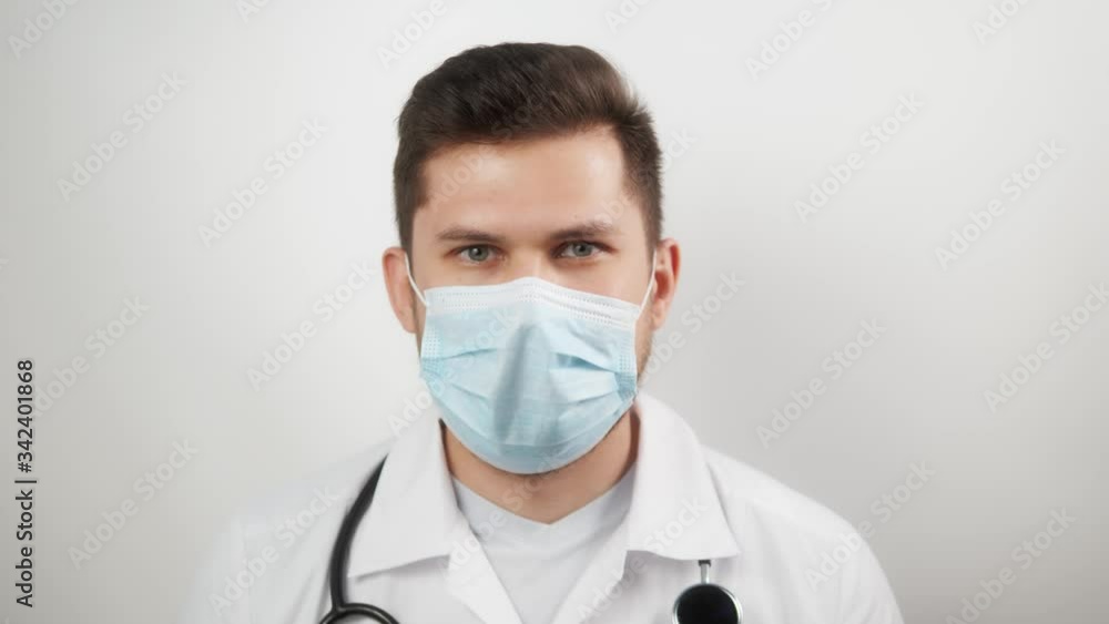 tired medical man worker doctor after taking a large number of patients due to the epidemic of coronavirus, portrait male doctor in medical protective mask tired medical man worker doctor after taking a large number of patients due to the epidemic of coronavirus, portrait male doctor in medical protective mask