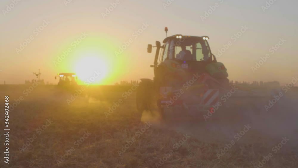 combine harvester working at sunset combine harvester working at sunset