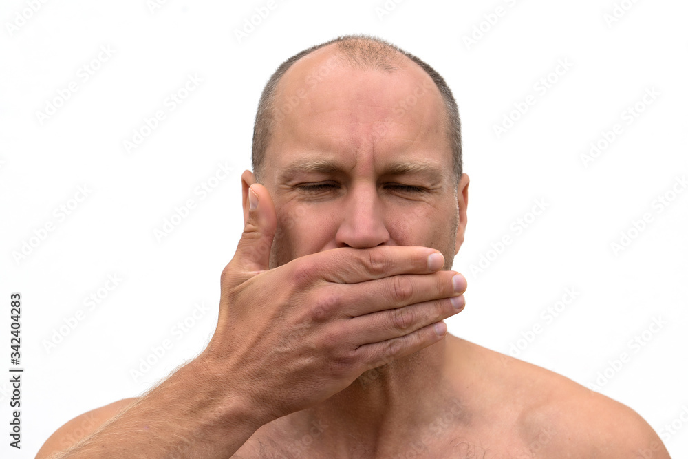 Naklejka premium Close up portrait man covering mouth with his hand.