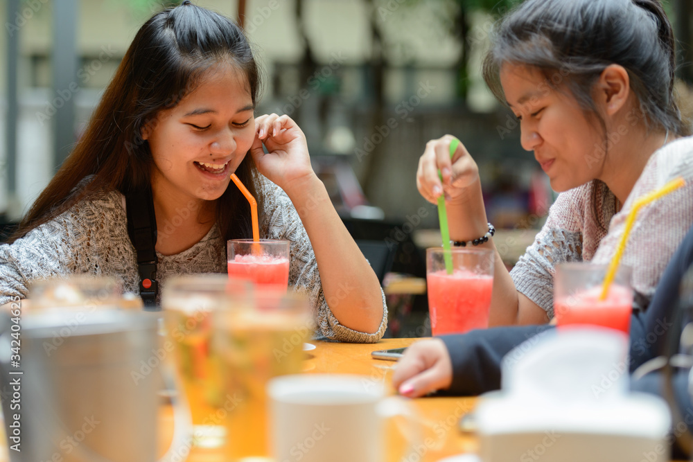 Group of young Asian women as friends hanging out together outdoors Group of young Asian women as friends hanging out together outdoors