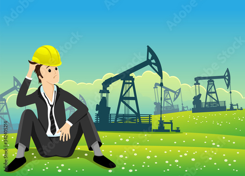 Oilman in a helmet sits on a field with oil rigs.