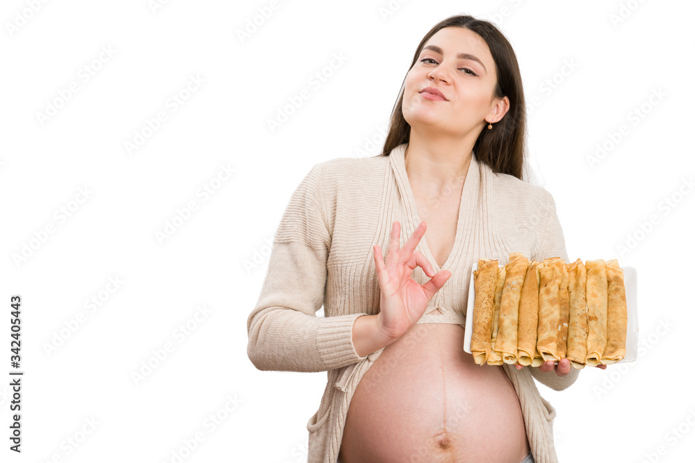 Proud pregnant woman making perfect gesture and holding pancakes Proud pregnant woman making perfect gesture and holding pancakes