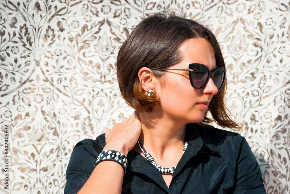 Portrait of beautiful woman with geometric jewelry set in black and white. Minimalist bracelet, earrings and necklace. Portrait of beautiful woman with geometric jewelry set in black and white. Minimalist bracelet, earrings and necklace.