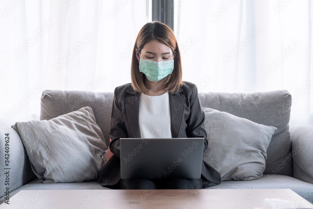 Self-detention, Coronavirus,Work from home concept, Young Asian woman in a suit is sitting and working at her house. Self-detention, Coronavirus,Work from home concept, Young Asian woman in a suit is sitting and working at her house.
