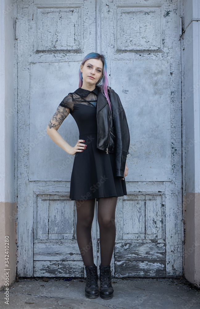 Young blue violet haired girl near the old door Young blue violet haired girl near the old door