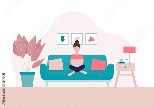 Woman sitting on a sofa with laptop  in her living room in period of self isolation and social distancing during Covid-19 virus epidemic. Stay home concept. Freelance or studying concept.