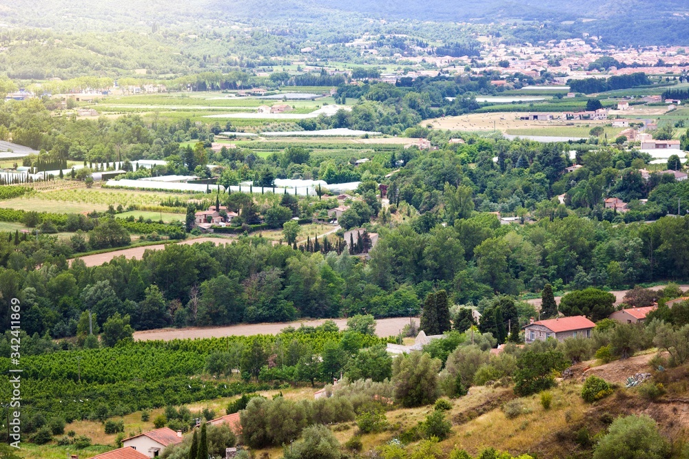 Views of Languedoc-Roussillon from village Eus, France. Tiled roof houses, vineyards and mountains in summer