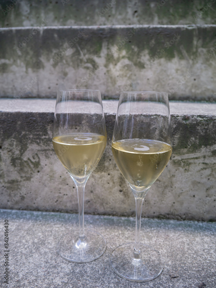 two glasses of champagne on stone stairs two glasses of champagne on stone stairs