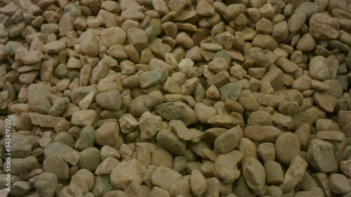 A 4K side view shot shot of grit, building material, gardening material. Mid shot of material rotating. Gardening and Landscape material.