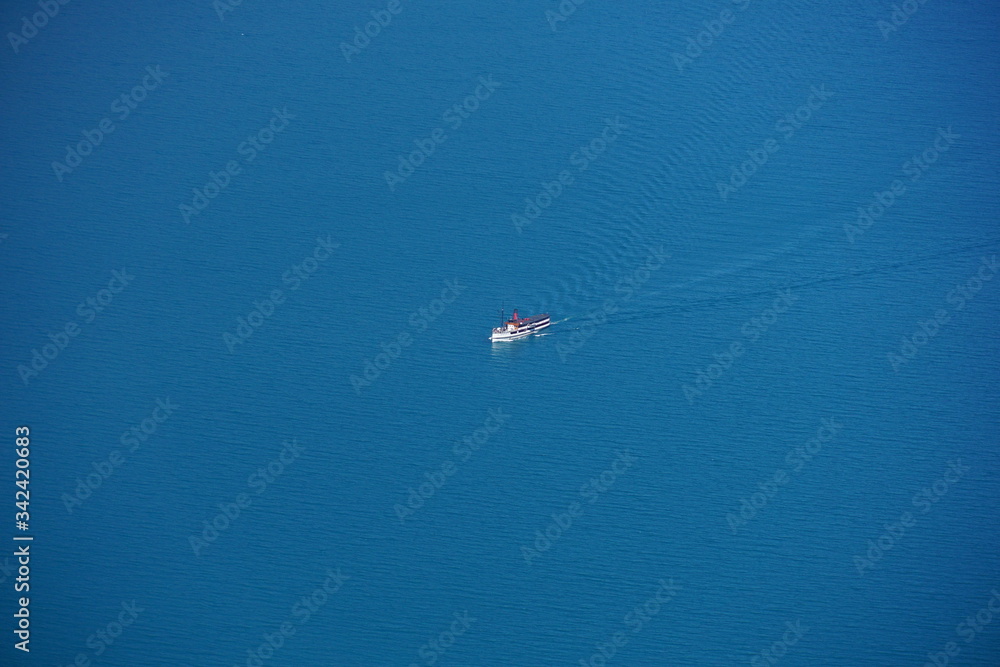 QUEENSTOWN, NEW ZEALAND - MARCH 14, 2020: Steam boat in lake Wakatipu from above