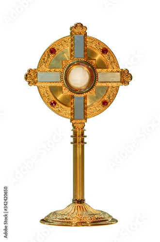 monstrance or ostensorium displaying the consecrated host, the Body of Christ isolated on white background photo