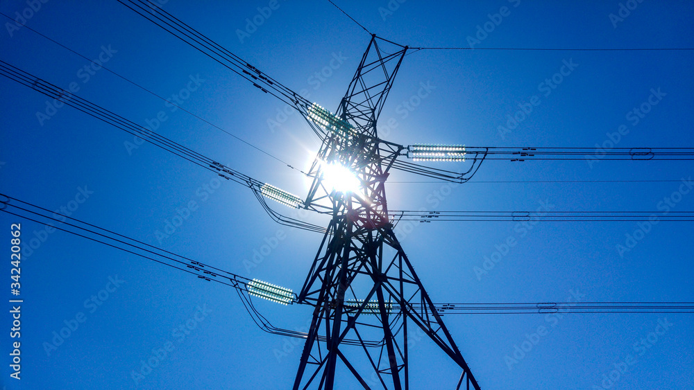 Φωτογραφία Low angle of power lines against blue sky and sun, Johannesburg, South Africa