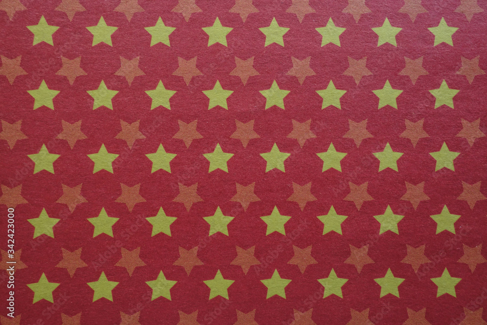 Red background with purple stars, texture of gift paper wrapper or cardboard