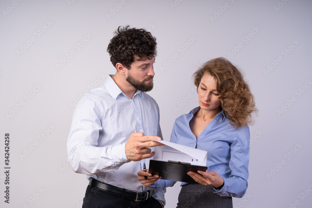 The man and woman in business style clothes, read the document focused, gender The man and woman in business style clothes, read the document focused, gender