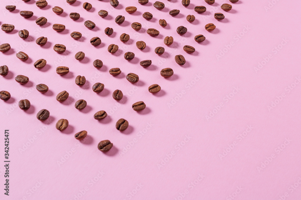 Coffee beans on a pink background. Food Background. Place for text. Selective focus. Coffee beans on a pink background. Food Background. Place for text. Selective focus.