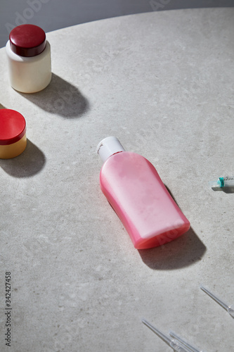 pink bottle with hydroalcoholic gel to disinfect hands and maintain hygiene