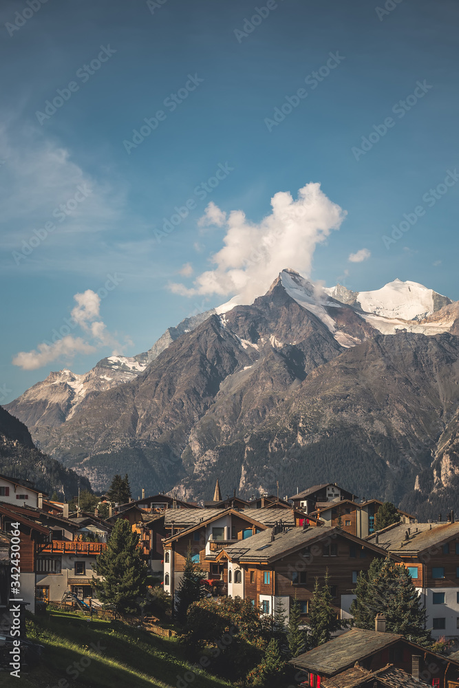 view of a village in switzerland, sunny landscape in the mountains