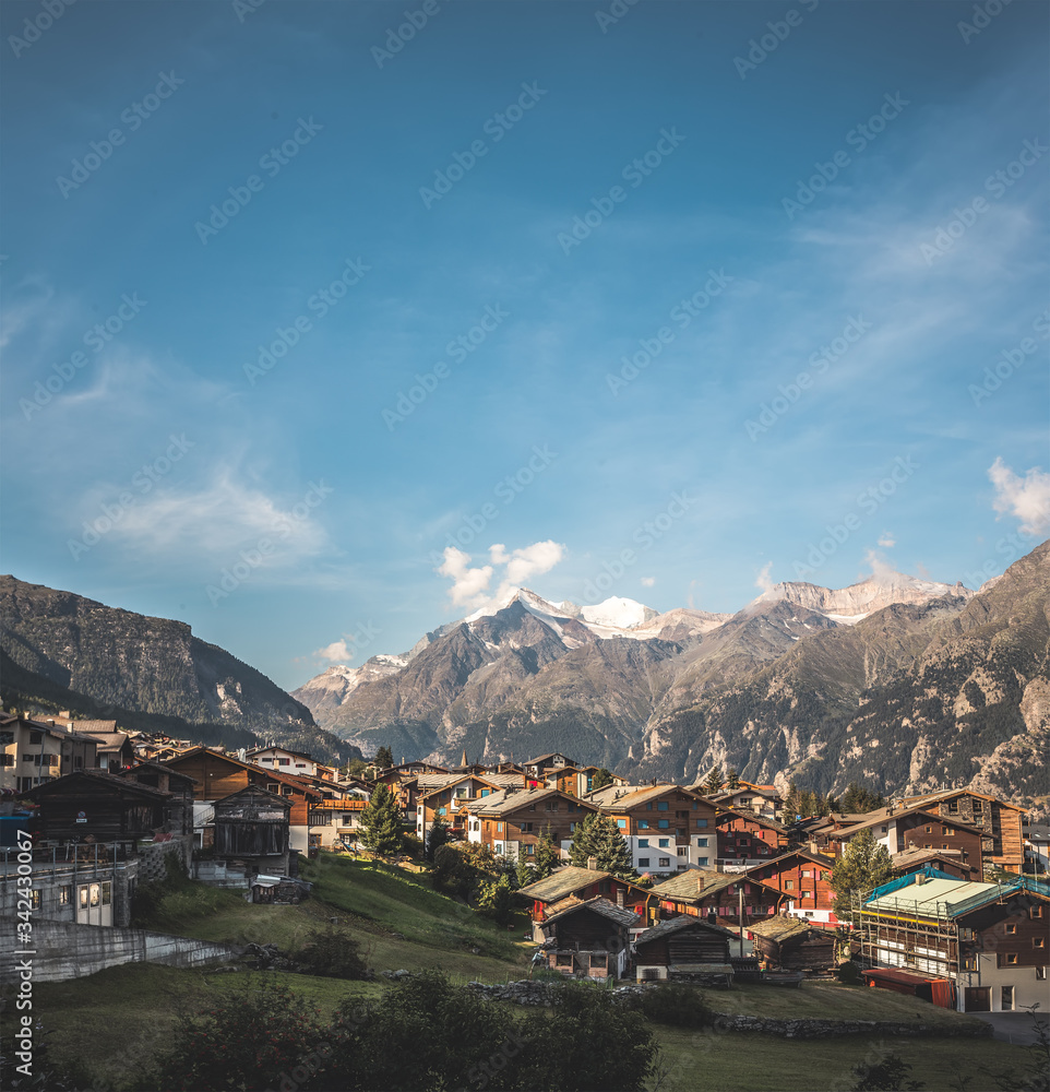 view of a village in switzerland, sunny landscape in the mountains