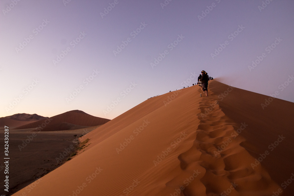 Climbing big dune at Sossusvlei, Namibia Climbing big dune at Sossusvlei, Namibia